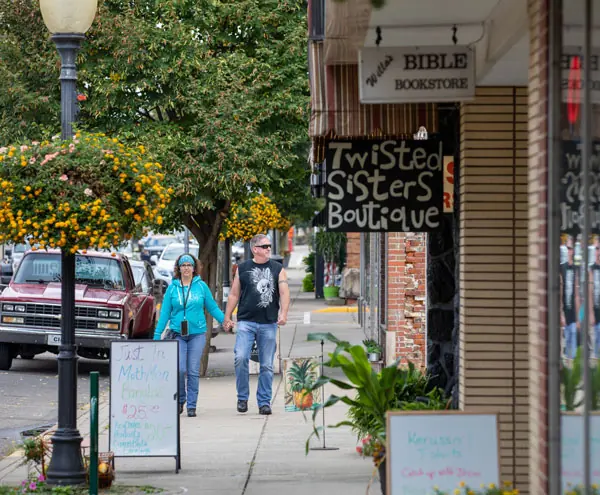 Historic Main Street with the Lowe Hotel sign and hanging flower baskets